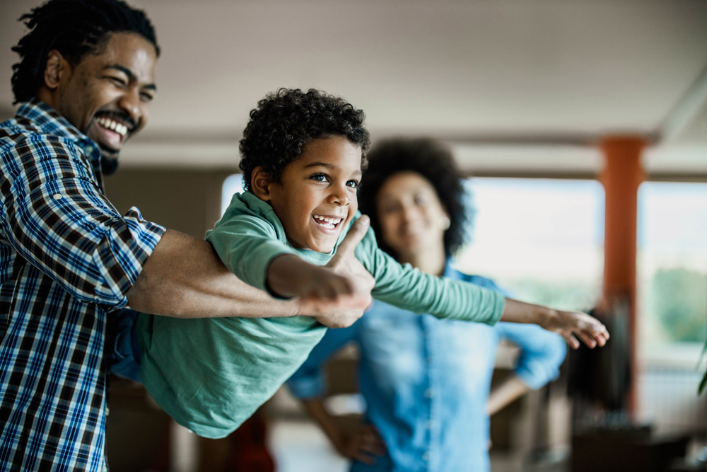 boy flying with dad - fun
